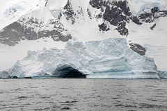 03A Zodiac Dwarfed By A Huge Iceberg With A Small Cave Near Danco Island On Quark Expeditions Antarctica Cruise.jpg